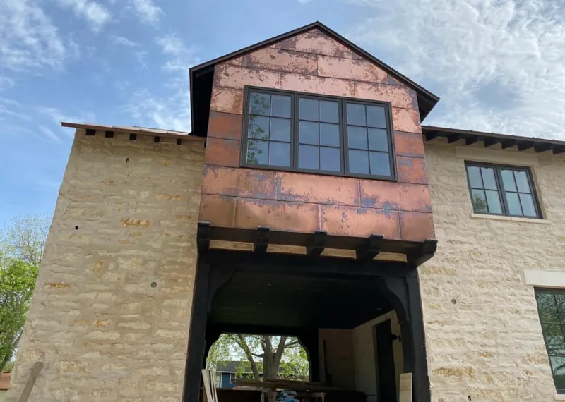 Copper metal panel facade on a stone building for Roof Repair in Wildewood