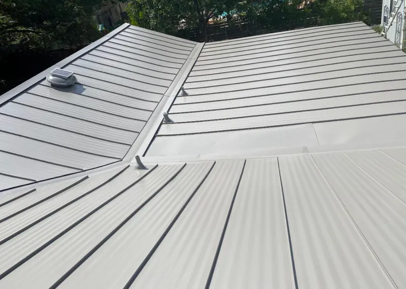 Solar attic fan installed on a metal roof for Roof Ventilation in Wildewood